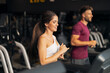 © Jelena - A beautiful athletic young adult woman using a treadmill at the gym