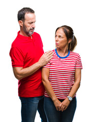 Wall Mural - Middle age hispanic couple in love over isolated background skeptic and nervous, frowning upset because of problem. Negative person.