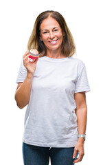 Middle age hispanic woman eating cupcake over isolated background with a happy face standing and smiling with a confident smile showing teeth