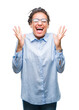 © Krakenimages.com - Young braided hair african american business girl wearing glasses over isolated background celebrating mad and crazy for success with arms raised and closed eyes screaming excited. Winner concept
