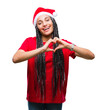 © Krakenimages.com - Young braided hair african american girl wearing christmas hat over isolated background smiling in love showing heart symbol and shape with hands. Romantic concept.