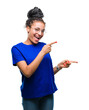 © Krakenimages.com - Young braided hair african american girl wearing glasses over isolated background smiling and looking at the camera pointing with two hands and fingers to the side.