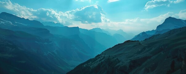 A panoramic aerial view of blue mountain ranges with misty valleys, showing natural majesty and serene outdoor landscape. banner