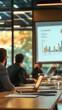 © Maria Mikhaylichenko - Business professionals attentively viewing financial data presentation on large screen in modern conference room, laptops open for note-taking and analysis.