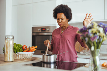 Woman Cooking in Modern Kitchen with Fresh Vegetables