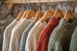 © Anton - Cardigans. Conscious Fashion Trend: Warm Winter Ladies Clothes Collection on Wooden Hangers
