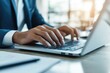 © Synthetica - A man is typing on a laptop in a suit