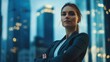 © indyntk - Dynamic editorial image of a determined businesswoman in power stance in modern skyscraper office city skyline background emphasizing corporate success and leadership
