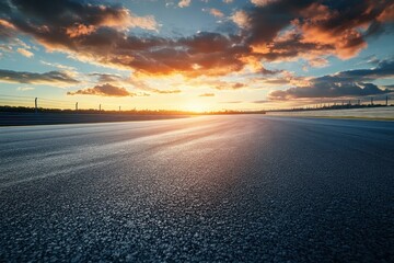 Wall Mural - Sunset with asphalt race track and clouds in sky