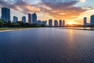 Urban skyline lake and sunset on asphalt road