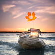 © Jenny Sturm - glass with a colorful autumn leaf at the ocean