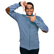 © Krakenimages.com - Young handsome hispanic man wearing casual sweatshirt smiling making frame with hands and fingers with happy face. creativity and photography concept.
