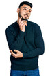 © Krakenimages.com - Young hispanic man with beard wearing casual winter sweater thinking concentrated about doubt with finger on chin and looking up wondering