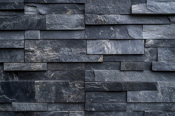 Dark gray slate wall cladding background, the texture of a natural stone panel for interior or exterior decoration.