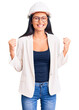 © Krakenimages.com - Young beautiful latin girl wearing architect hardhat and glasses celebrating surprised and amazed for success with arms raised and open eyes. winner concept.