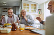 © Marko Geber - Diverse senior friends having breakfast together at home