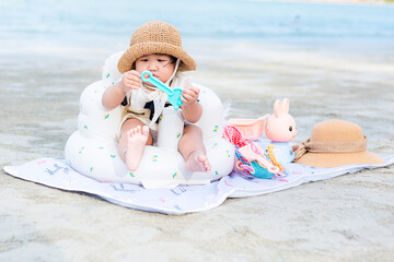 Girl playing in the sand on the beach on vacation,cute little girl play with sand on beach