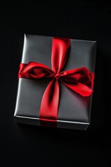 Sticker - Luxurious Silver Gift Box with Red Ribbon on Black Background - Perfect for Elegant Holiday Designs