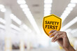 © ifriday - Hand holding safety first symbols for work safety, Safety first concept.