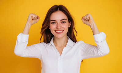 Canvas Print - Portrait of a beautiful, smiling woman in a white shirt standing against a yellow background.