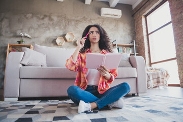 Wall Mural - Photo of doubtful unsure woman dressed orange shirt writing book indoors house apartment room