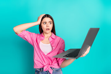 Canvas Print - Photo portrait of attractive teen woman hold netbook frightened dressed stylish pink clothes cyan on blue color background