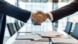 © JERRYsnipe.AI - Two business leaders shaking hands in a sleek conference room, with contract documents on the table, symbolizing the completion of a major business acquisition deal