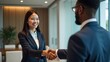 © GMeta - Corporate Diversity East Asian Businesswoman and Black Businessman Shaking Hands in Executive Office