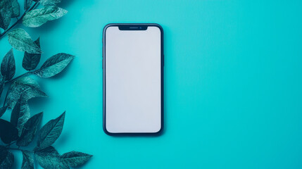 Wall Mural - A smartphone with a blank screen lies on a bright blue background with leafy greenery to the left.