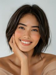 Wall Mural - smiling Filipino woman with modern bob cut, fashion makeup, glowing skin, shiny hair, posing hands touching face.