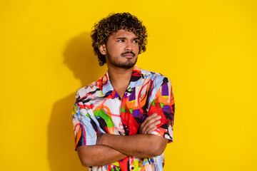 Portrait of nice young man folded arms look empty space wear shirt isolated on yellow color background