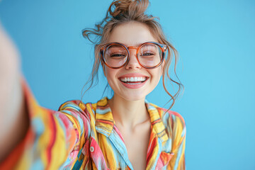 Poster - A woman with glasses and a smile on her face is taking a selfie