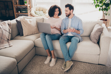 Poster - Photo of two people girl guy sit couch using netbook showing ads in apartment room indoors