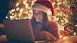 © Togrul - Joyous woman with laptop and Christmas tree.