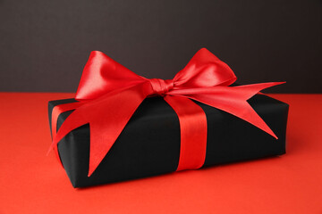 Poster - Gift box with red bow on color background