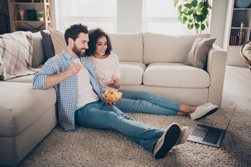 Poster - Full size photo of two nice young partners watch movie eat chips weekend modern apartment indoors