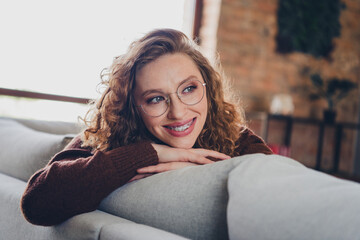 Photo of adorable lovely dreamy woman dressed trendy clothes comfortable apartment furniture house indoors