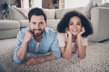 Canvas Print - Photo of two young idyllic partners laying floor modern interior living room apartment indoors