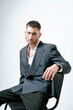 © Elina Leonova - Handsome man, fashion model sits on chair