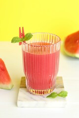 Canvas Print - Tasty watermelon drink in glass and fresh fruit on white table, closeup