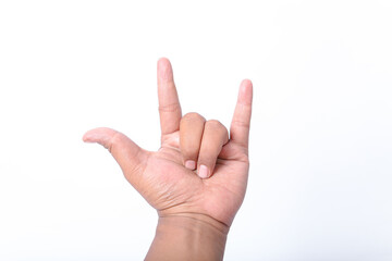 Male hand close-up on a white background shows hand gesture. Rock'n'roll. Isolated on white background.