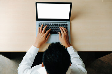 Wall Mural - Business person or office worker using laptop computer while sitting at desk. uds