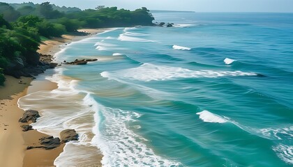 The green sea water is connected to the golden sandy beach, and the waves gently beat the shore, forming a natural and beautiful scene, showing a tranquil and harmonious coastal scenery.