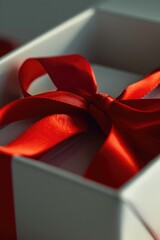 Wall Mural - A small, white box tied with a bright red ribbon