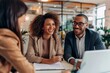 © Yevhen - Joyful young couple engaging with a female real estate agent in a professional office setting