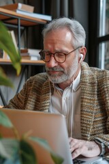 Poster - A person sitting at a desk with a laptop open, possibly working or studying