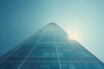 Poster - A modern skyscraper against a clear blue sky, great for business or architecture themes