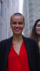 Wall Mural - Vertical Portrait diverse laughing professionals business women. Leadership lady looking at camera and group empowered and cheerful entrepreneur females in formal suits joyful and confident outdoor