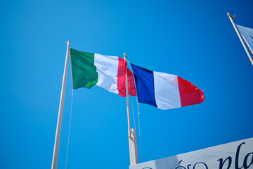 Flags of italy and france waving together