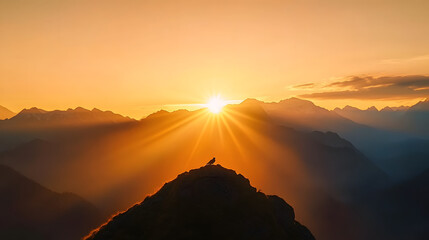 Sticker - The sun descends over mountains as a bird rests atop a peak